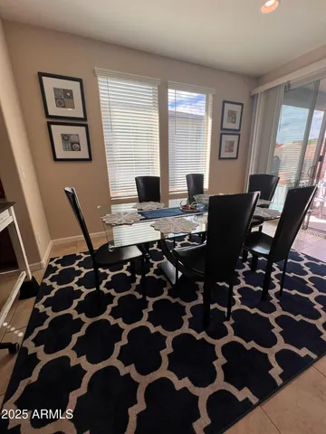 a view of a workspace with furniture and window