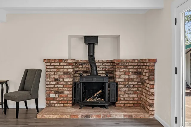 a view of living room with furniture and a fireplace