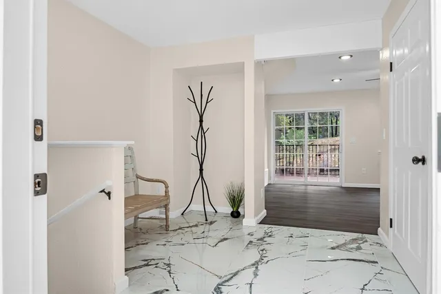 a view of a bedroom with a bed and glass door