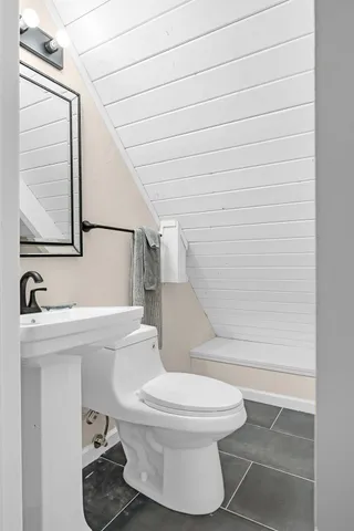 a white toilet sitting next to a bathroom sink