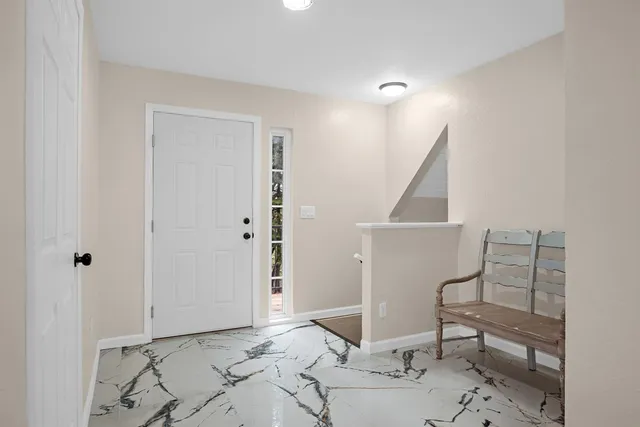 a view of entryway with workspace and bathroom