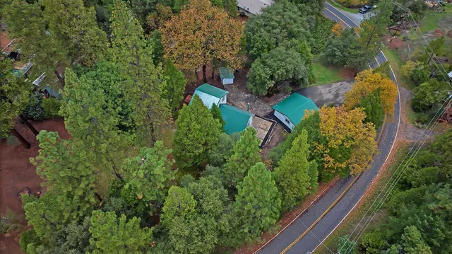 an aerial view of a house with garden space and street view