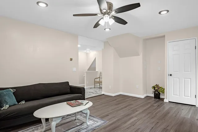a living room with furniture and a wooden floor