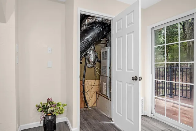 a view of a hallway with wooden floor and a entryway