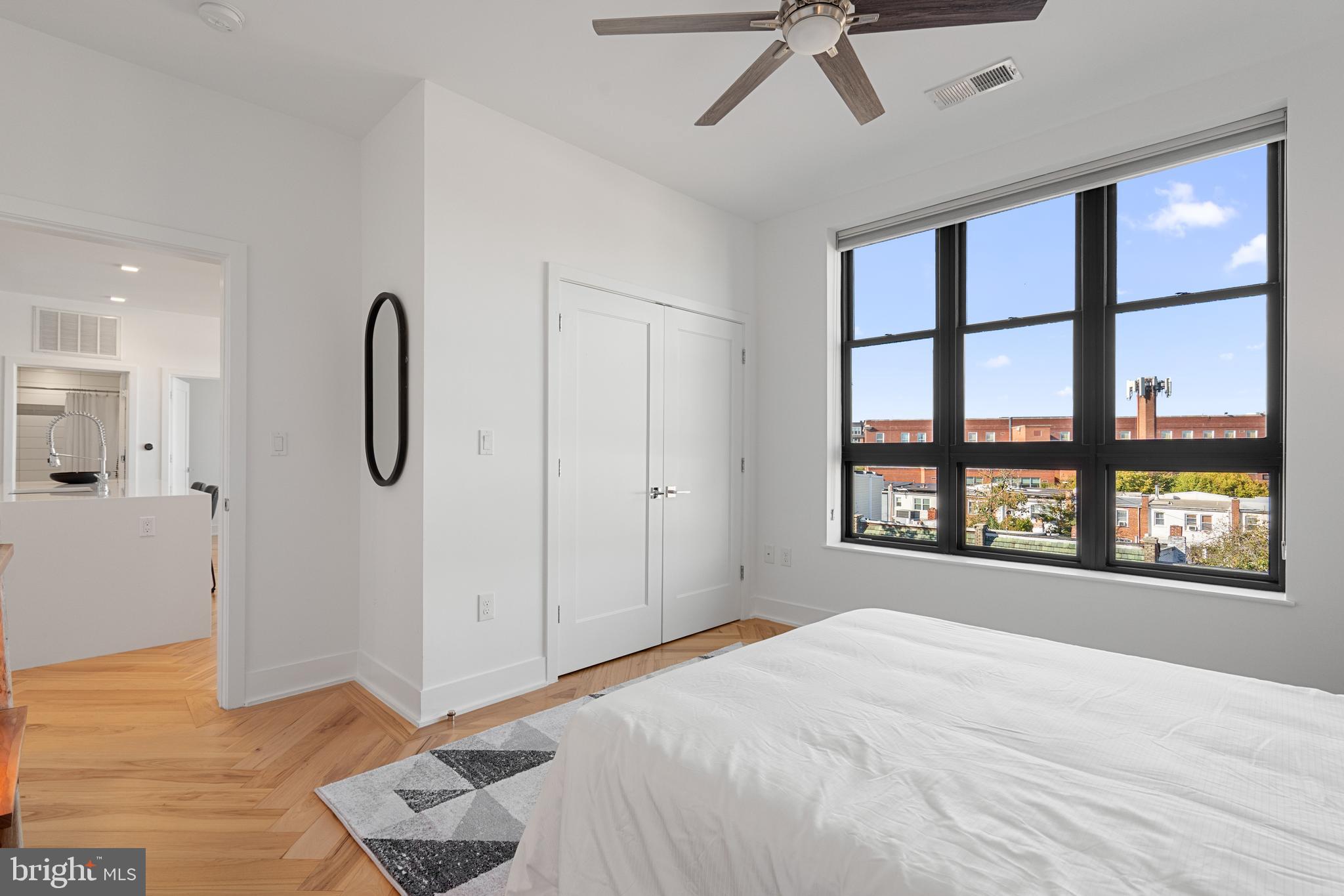 1345 K Street Southeast, Unit 401 Washington, DC 20003 - Photo 12 of 28 a spacious bedroom with a large bed and a window