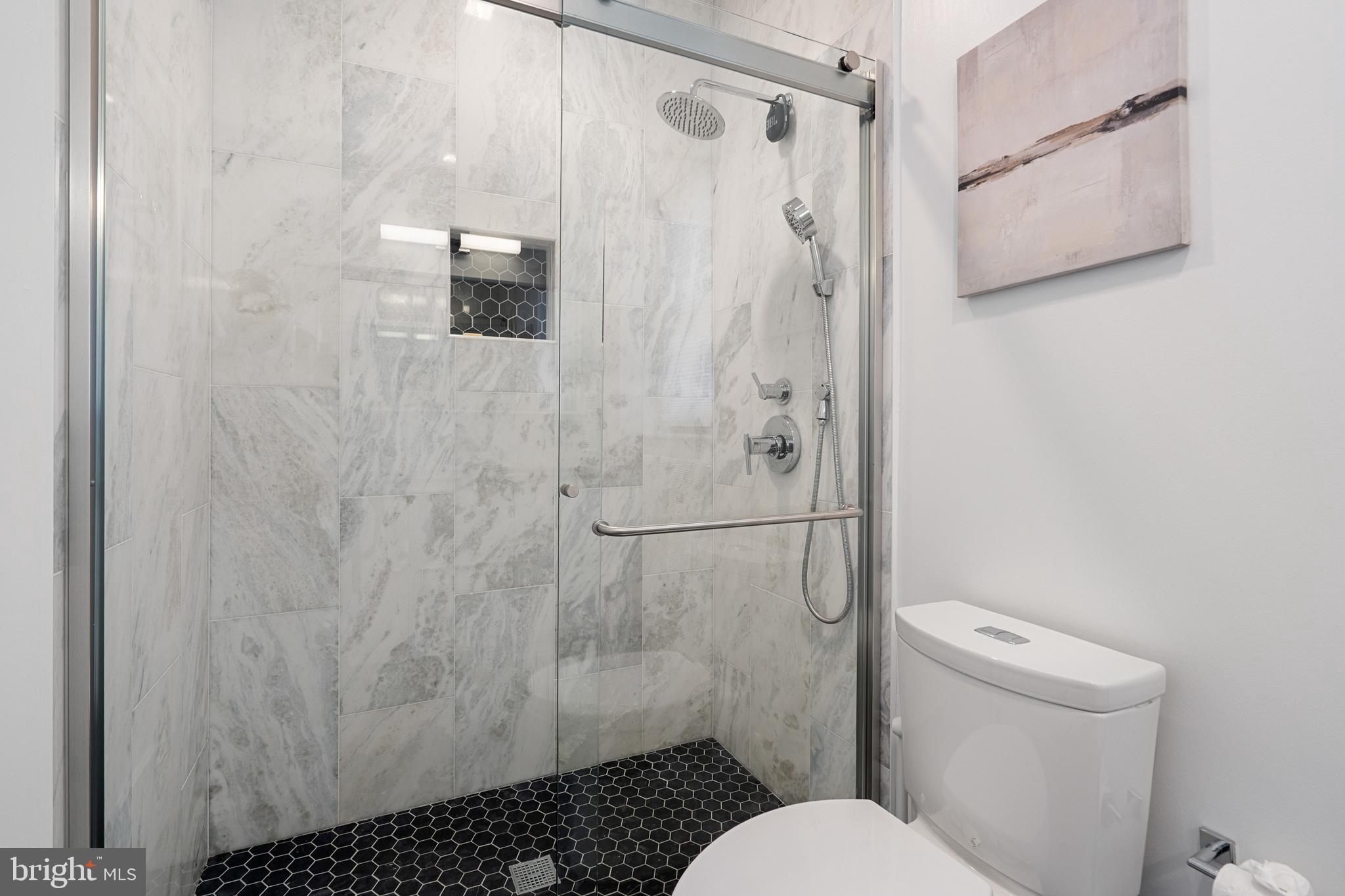 1345 K Street Southeast, Unit 401 Washington, DC 20003 - Photo 15 of 28 a bathroom with a shower toilet and sink