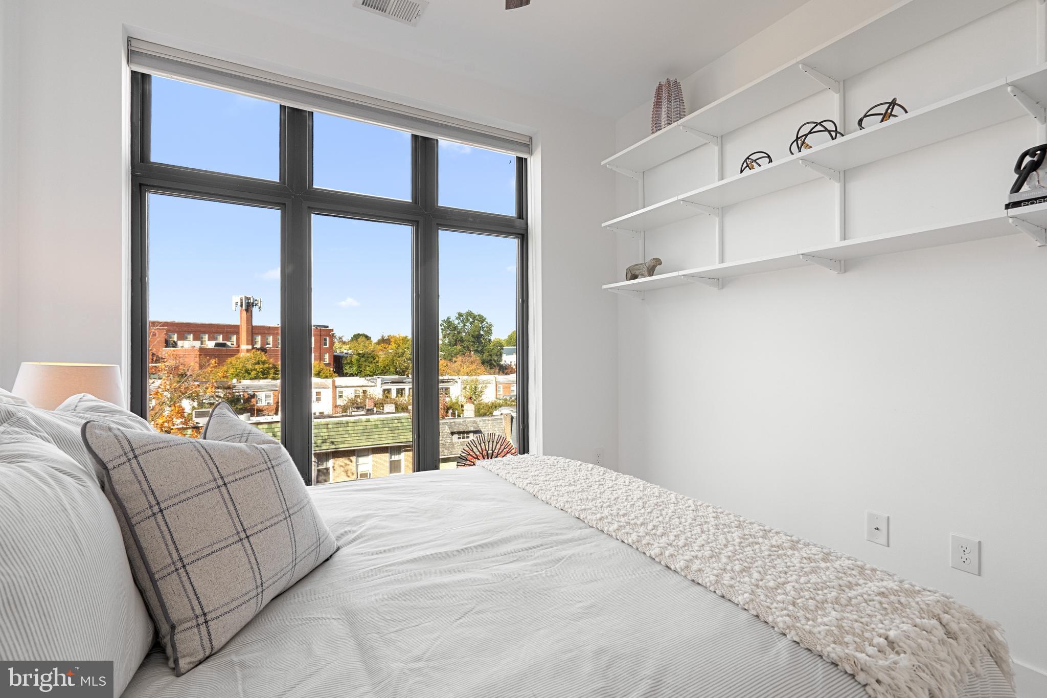 1345 K Street Southeast, Unit 401 Washington, DC 20003 - Photo 17 of 28 a bedroom with a large bed and a large window