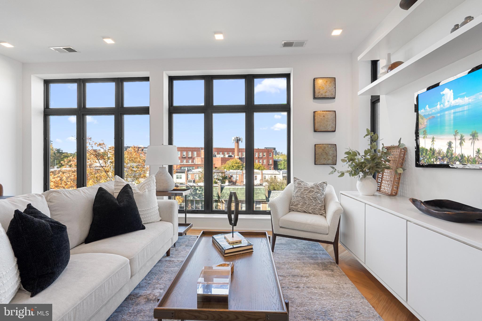 1345 K Street Southeast, Unit 401 Washington, DC 20003 - Photo 4 of 28 a living room with furniture and a large window