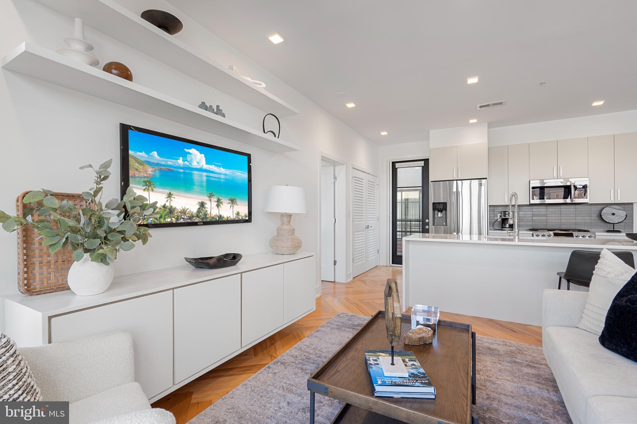 1345 K Street Southeast, Unit 401 Washington, DC 20003 - Photo 5 of 28 a living room with furniture and a flat screen tv