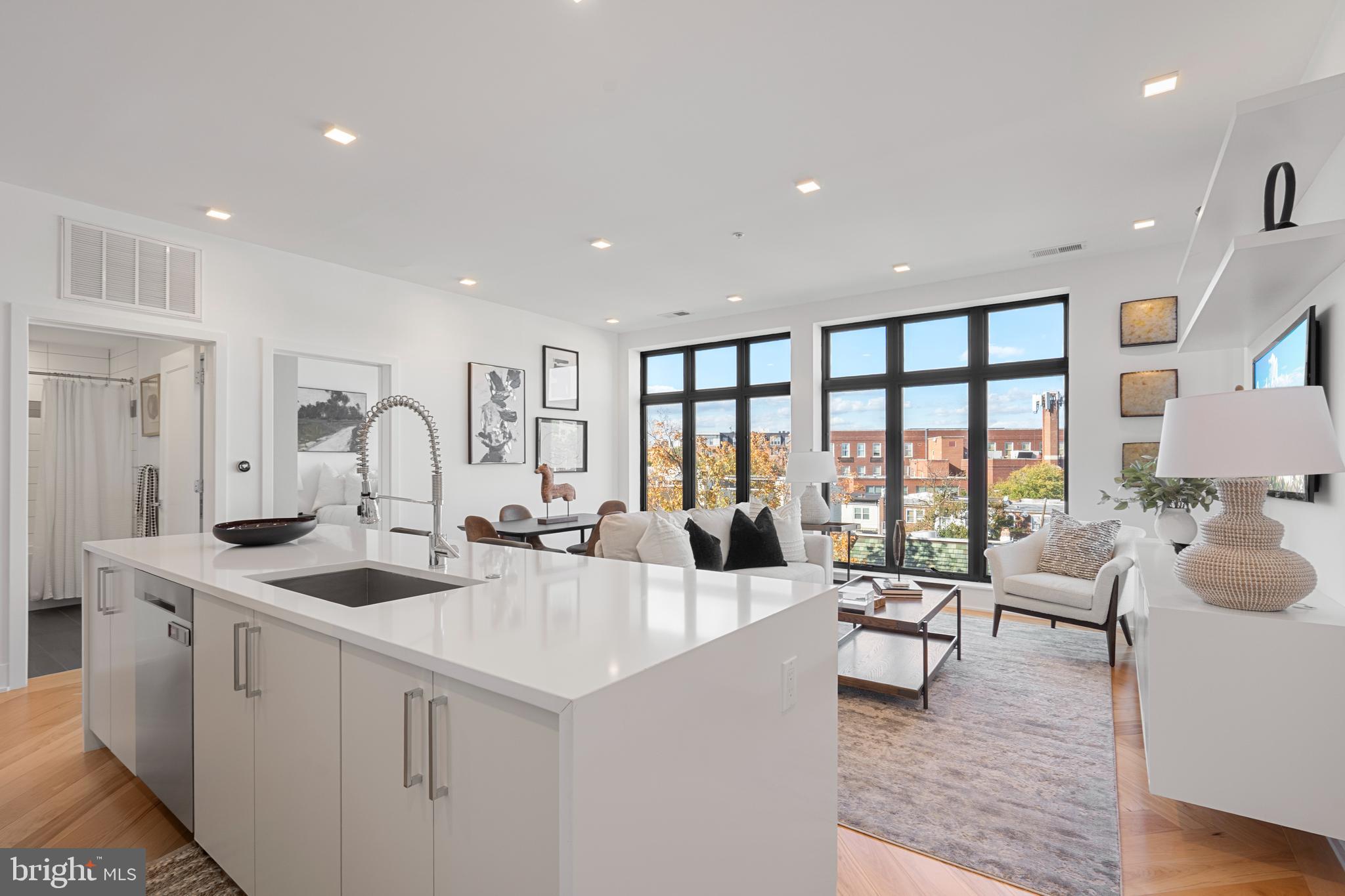 1345 K Street Southeast, Unit 401 Washington, DC 20003 - Photo 8 of 28 a very nice looking living room with a large window and couch