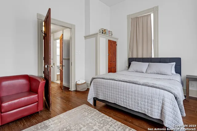 a bedroom with a bed couch and a window