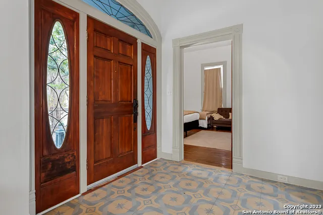 a bedroom with a bed and a mirror