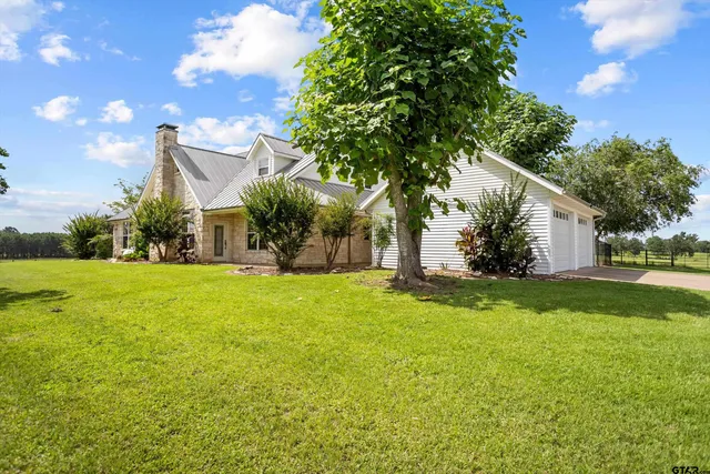 a front view of house with yard and green space