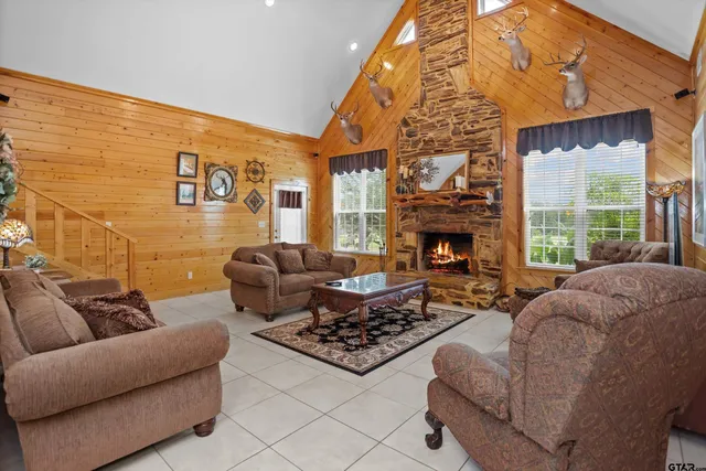 a living room with furniture a fireplace and a flat screen tv