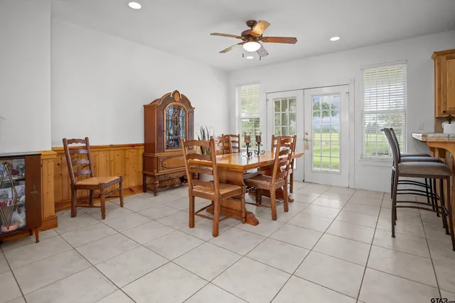 a view of a dining room with furniture and chandelier