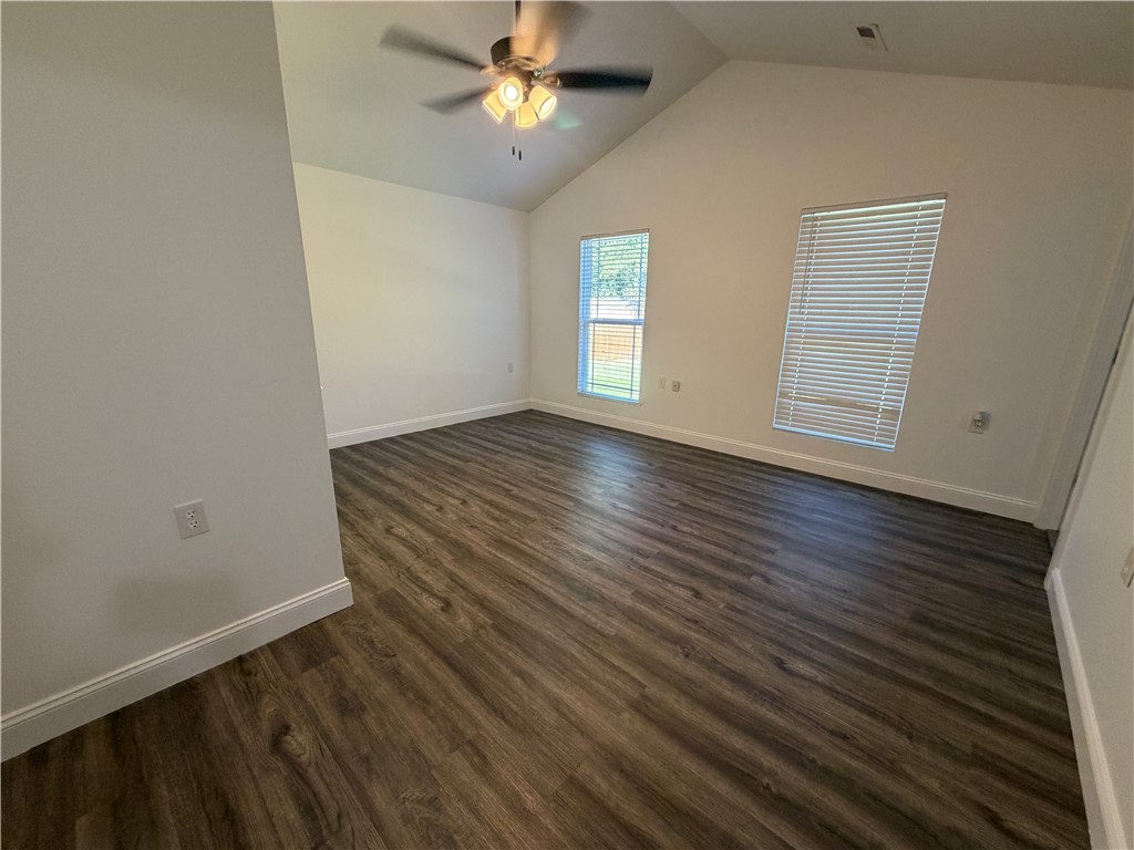 2910 Chambers Road Anderson, SC 29626 - Photo 5 of 16 Angled ceilings and wood-style flooring elevate this comfortable sleeping space.
