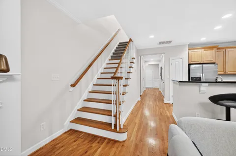 a view of a room with wooden floor and white walls