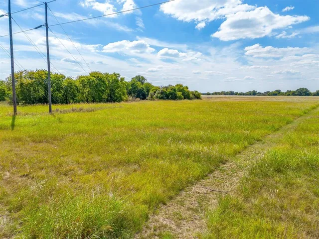 a view of an ocean beach and residential houses