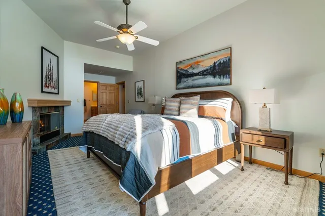 a bedroom with a bed and painting on the wall