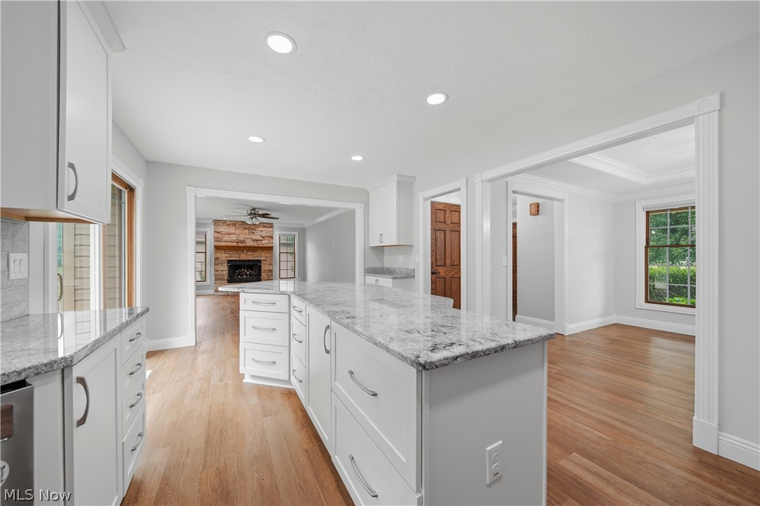 4764 Young Road Stow, OH 44224 - Photo 12 of 41 Kitchen featuring an expansive island with granite countertops, recessed lighting, wood-finish flooring, white cabinetry, and a stainless steel appliance