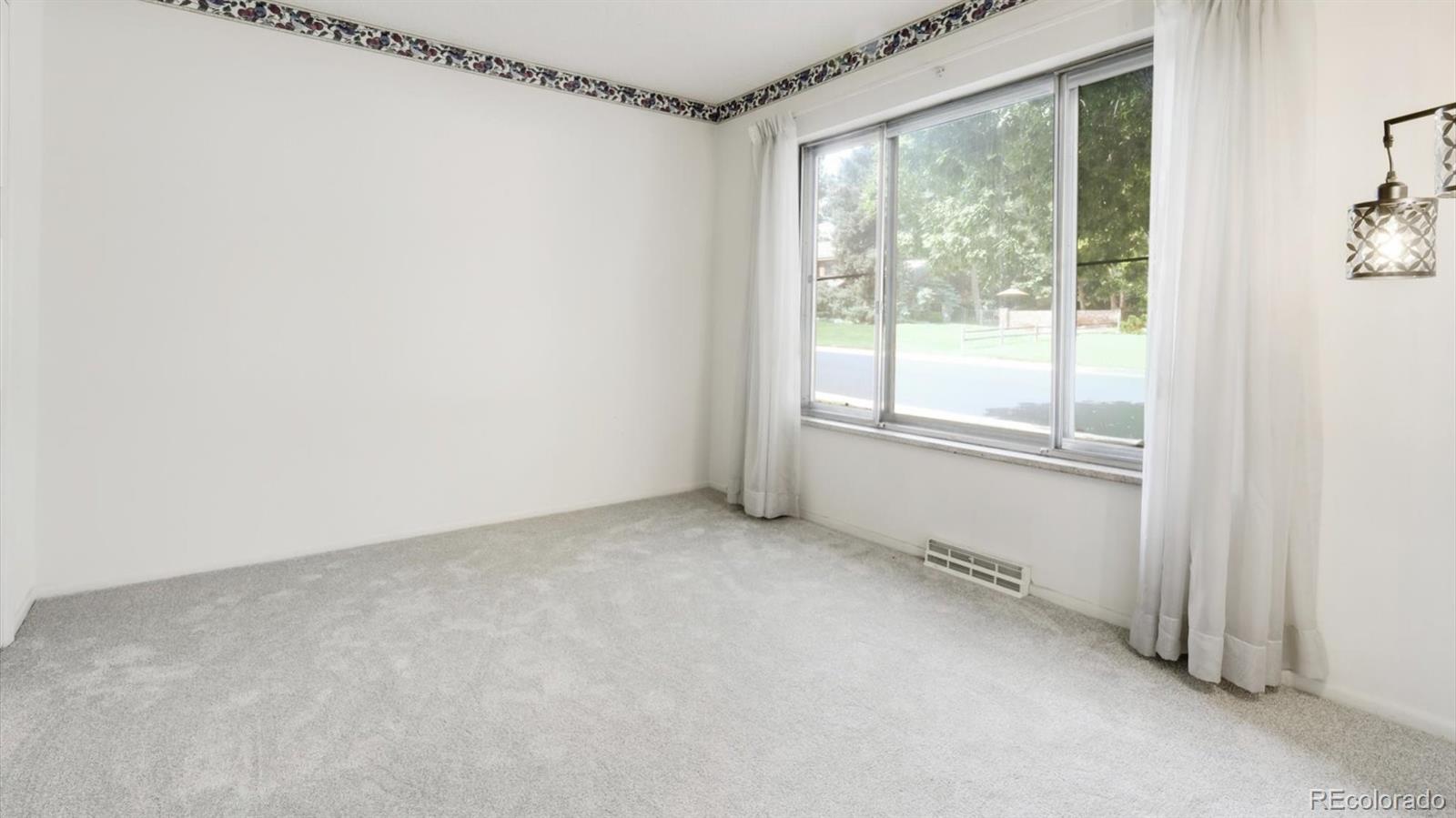 3292 South Oneida Way Denver, CO 80224 - Photo 12 of 44 a view of an empty room with a window