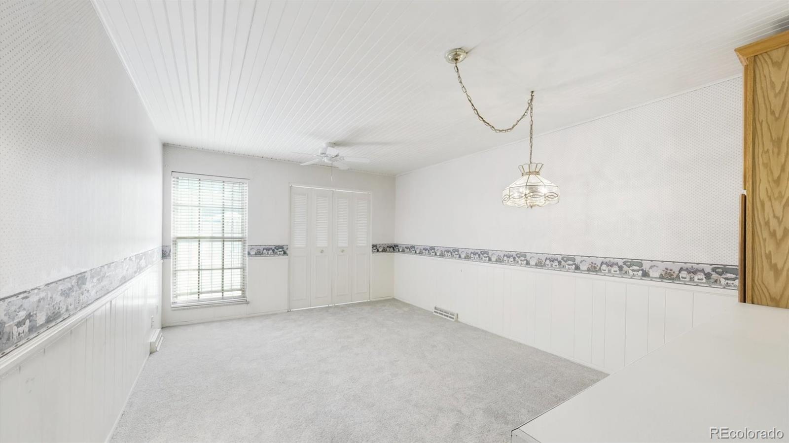 3292 South Oneida Way Denver, CO 80224 - Photo 17 of 44 a view of an empty room with chandelier fan