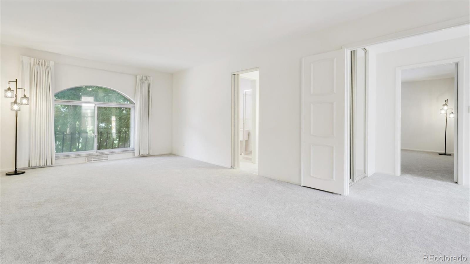 3292 South Oneida Way Denver, CO 80224 - Photo 21 of 44 an empty room with windows and entrance