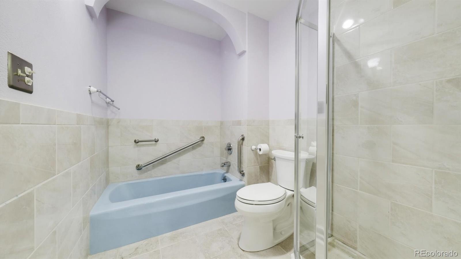 3292 South Oneida Way Denver, CO 80224 - Photo 26 of 44 a bathroom with a toilet and a bathtub