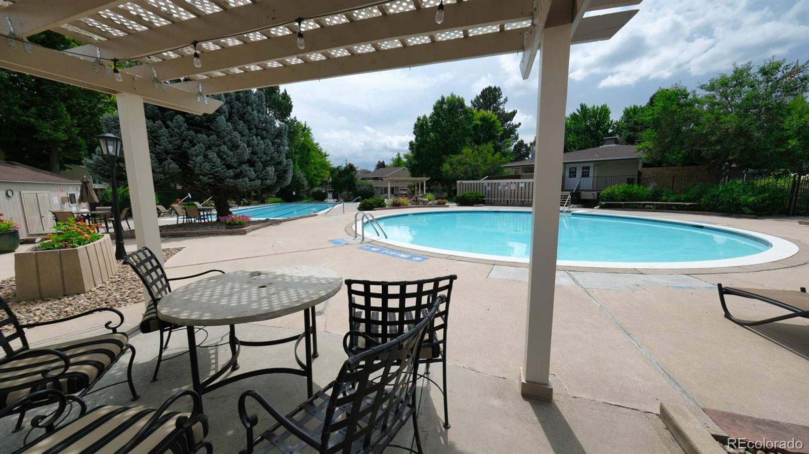 3292 South Oneida Way Denver, CO 80224 - Photo 35 of 44 a view of a patio with table and chairs with wooden floor and fence