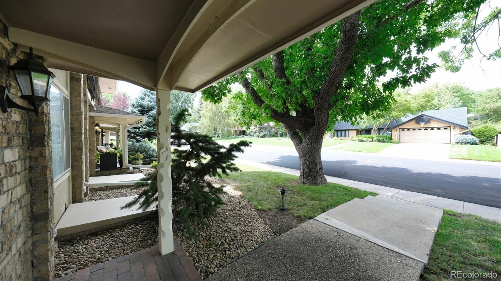 3292 South Oneida Way Denver, CO 80224 - Photo 5 of 44 a porch with chairs and table in patio
