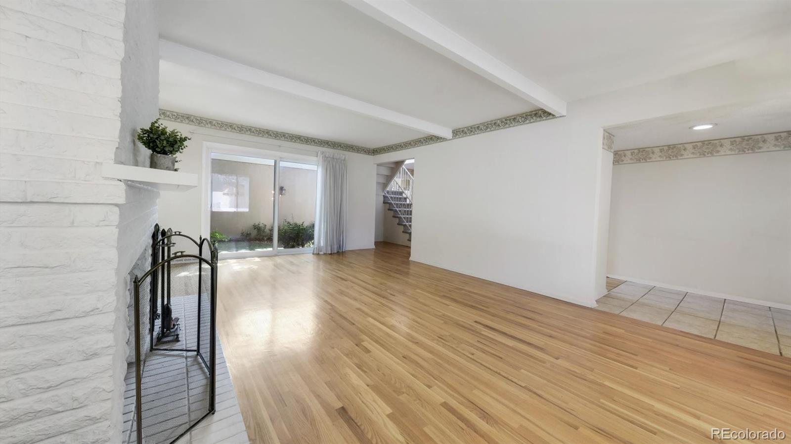 3292 South Oneida Way Denver, CO 80224 - Photo 9 of 44 a view of empty room with wooden floor