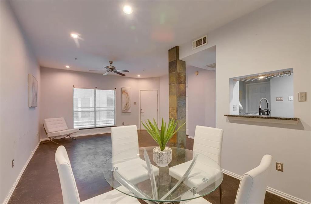 4104 North Hall Street, Unit 102 Dallas, TX 75219 - Photo 1 of 18 Open-concept living area featuring a pass-through window to the kitchen, recessed lighting, and a contemporary ceiling fan