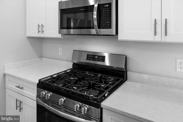 a stove top oven sitting inside of a kitchen