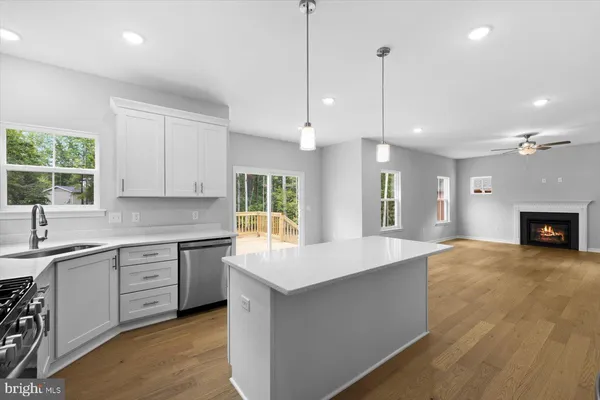 a large kitchen with kitchen island a sink stainless steel appliances and cabinets