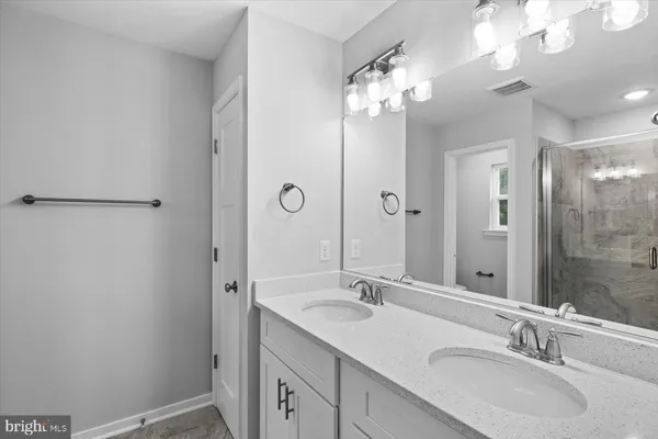 a bathroom with a glass shower door