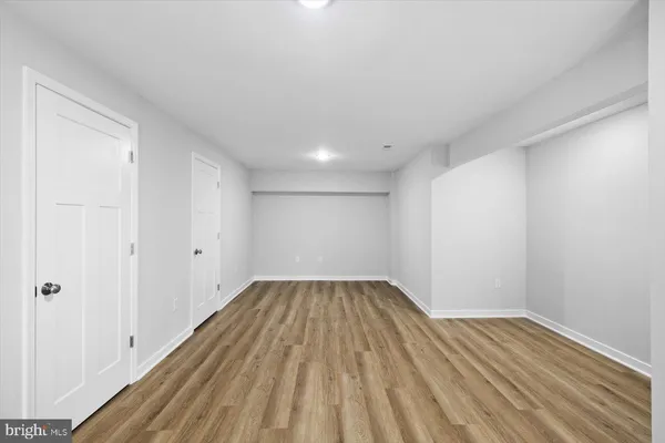 a view of an empty room and wooden floor