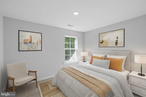 a bedroom with a large bed and a couch