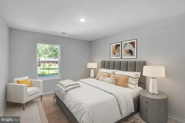 a bedroom with a bed and a couch