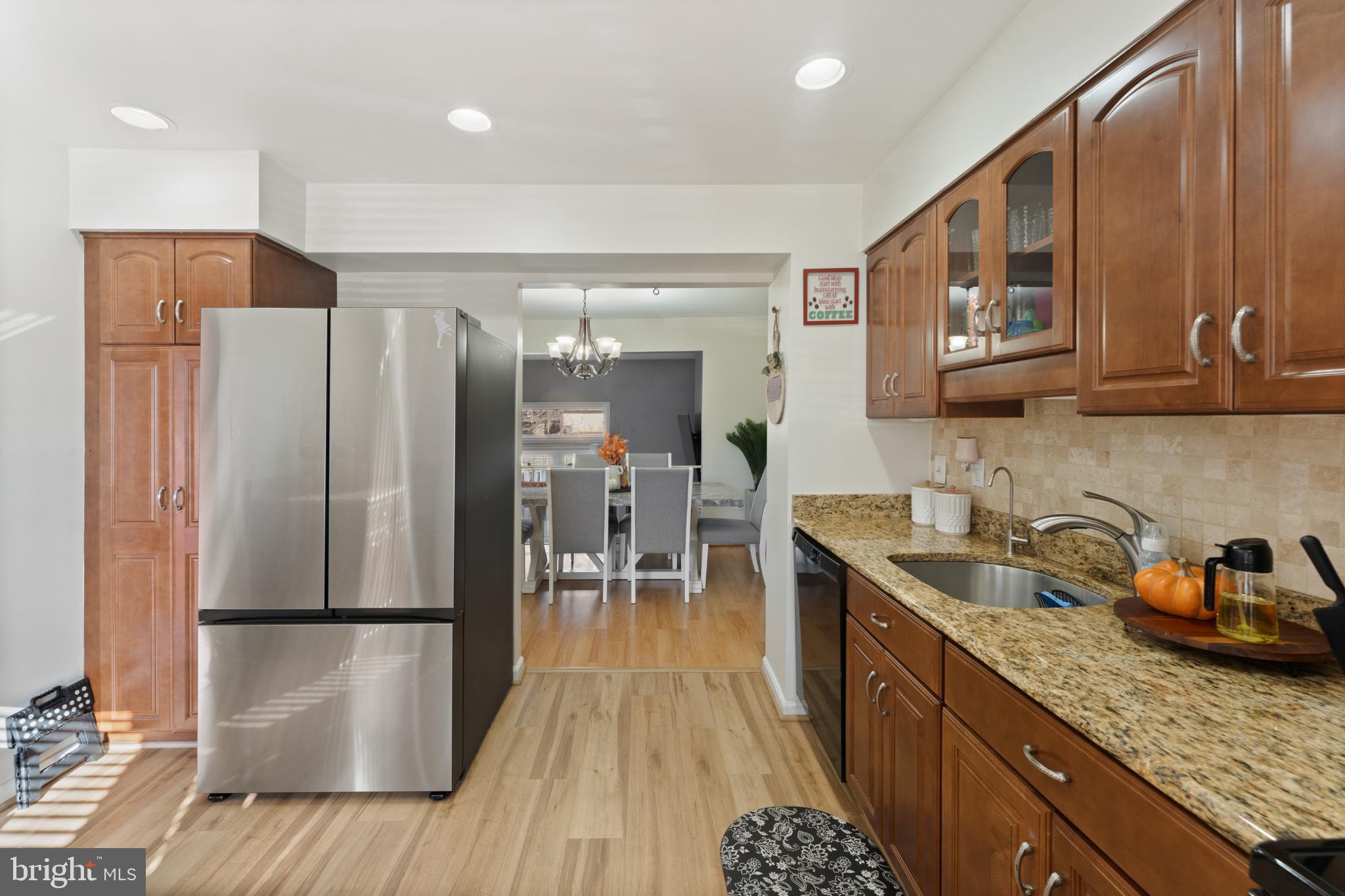 11 Briarstone Lane Gaithersburg, MD 20877 - Photo 12 of 31 a kitchen with stainless steel appliances granite countertop a refrigerator a sink and wooden cabinets