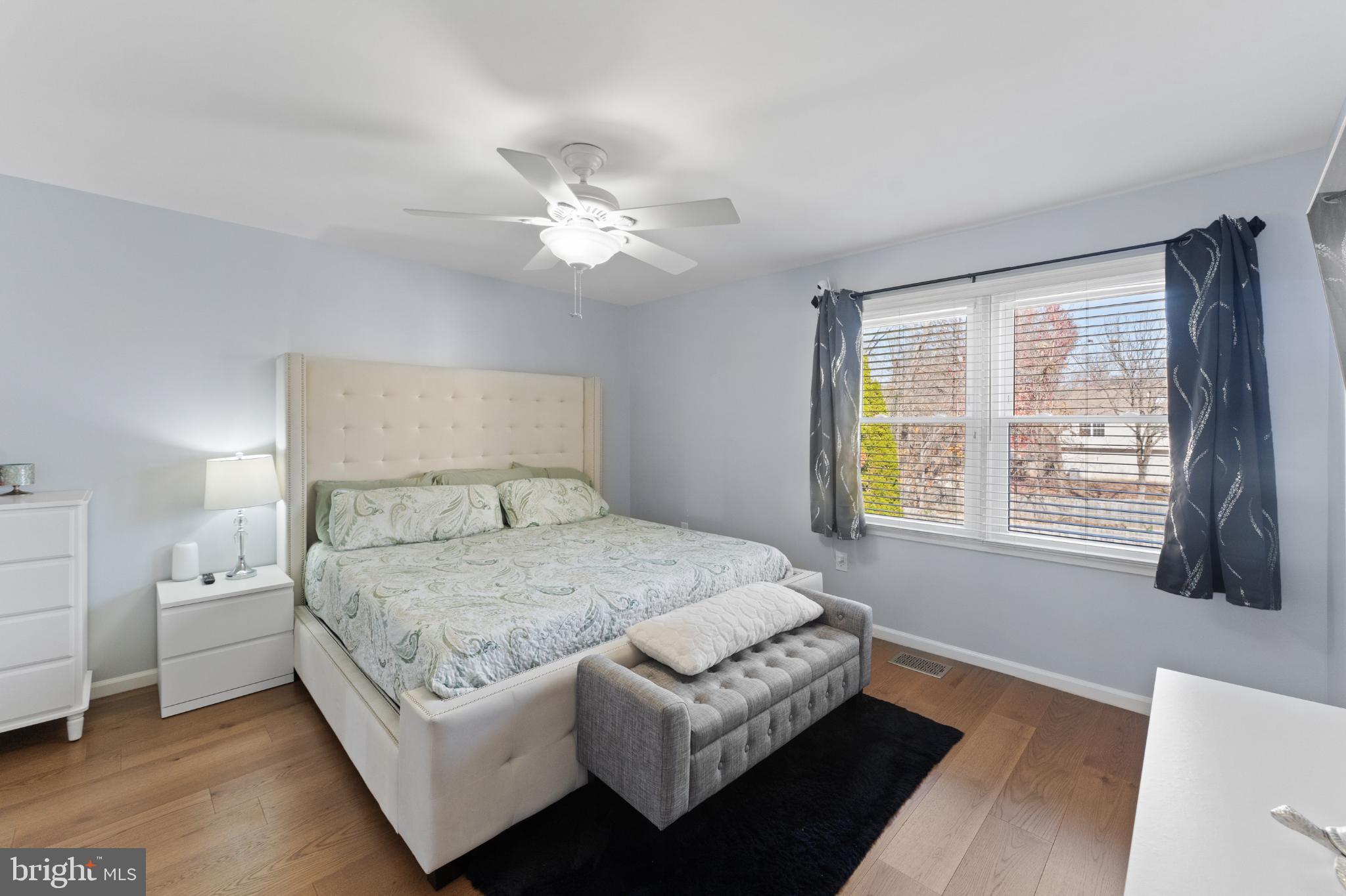 11 Briarstone Lane Gaithersburg, MD 20877 - Photo 20 of 31 a bedroom with a large bed and a chandelier