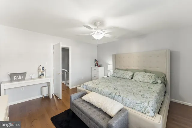 a bedroom with a large bed a chandelier and a couch