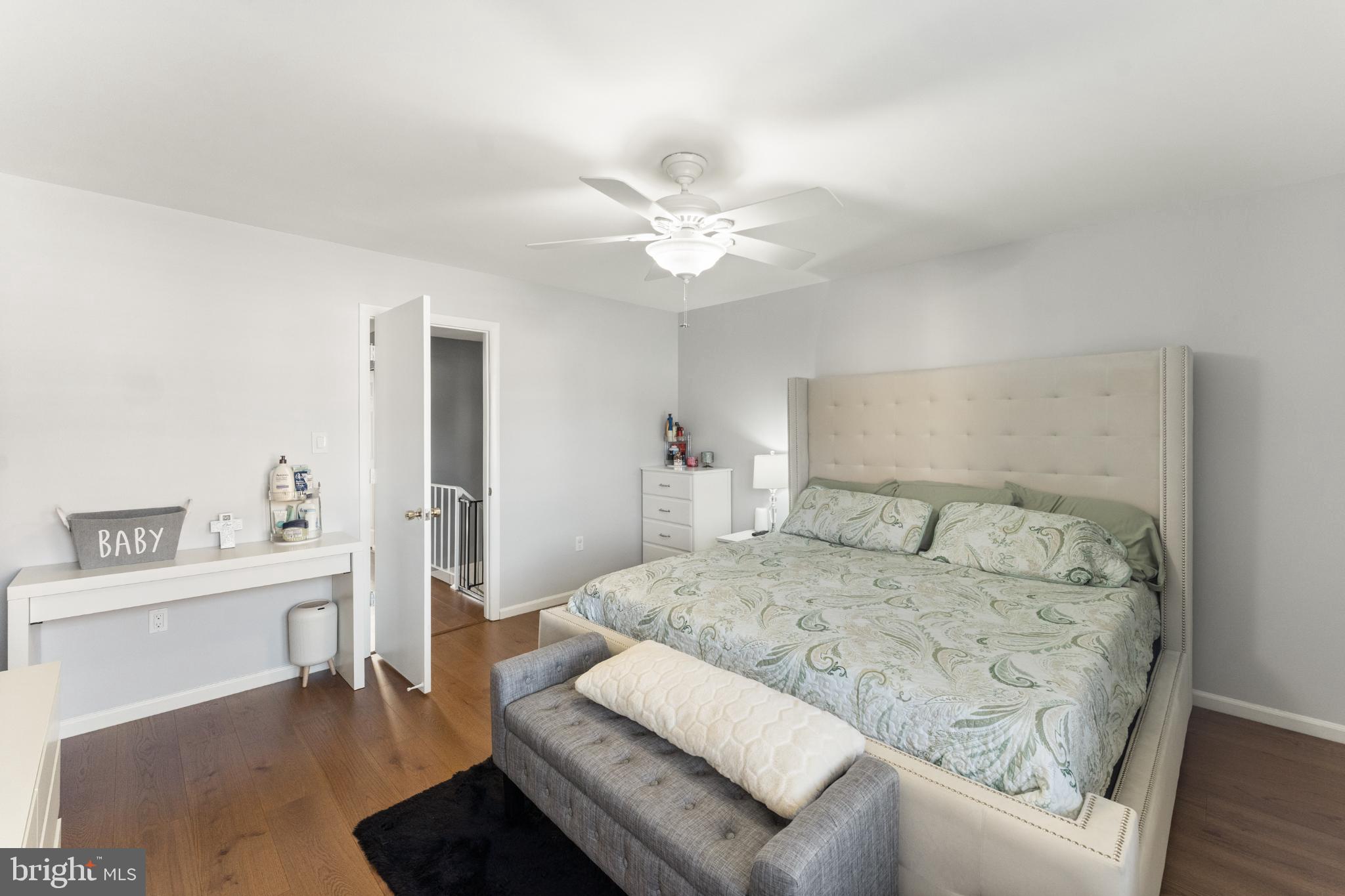 11 Briarstone Lane Gaithersburg, MD 20877 - Photo 23 of 31 a bedroom with a large bed a chandelier and a couch