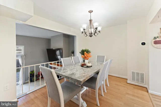 a view of a dining room with furniture wooden floor and chandelier
