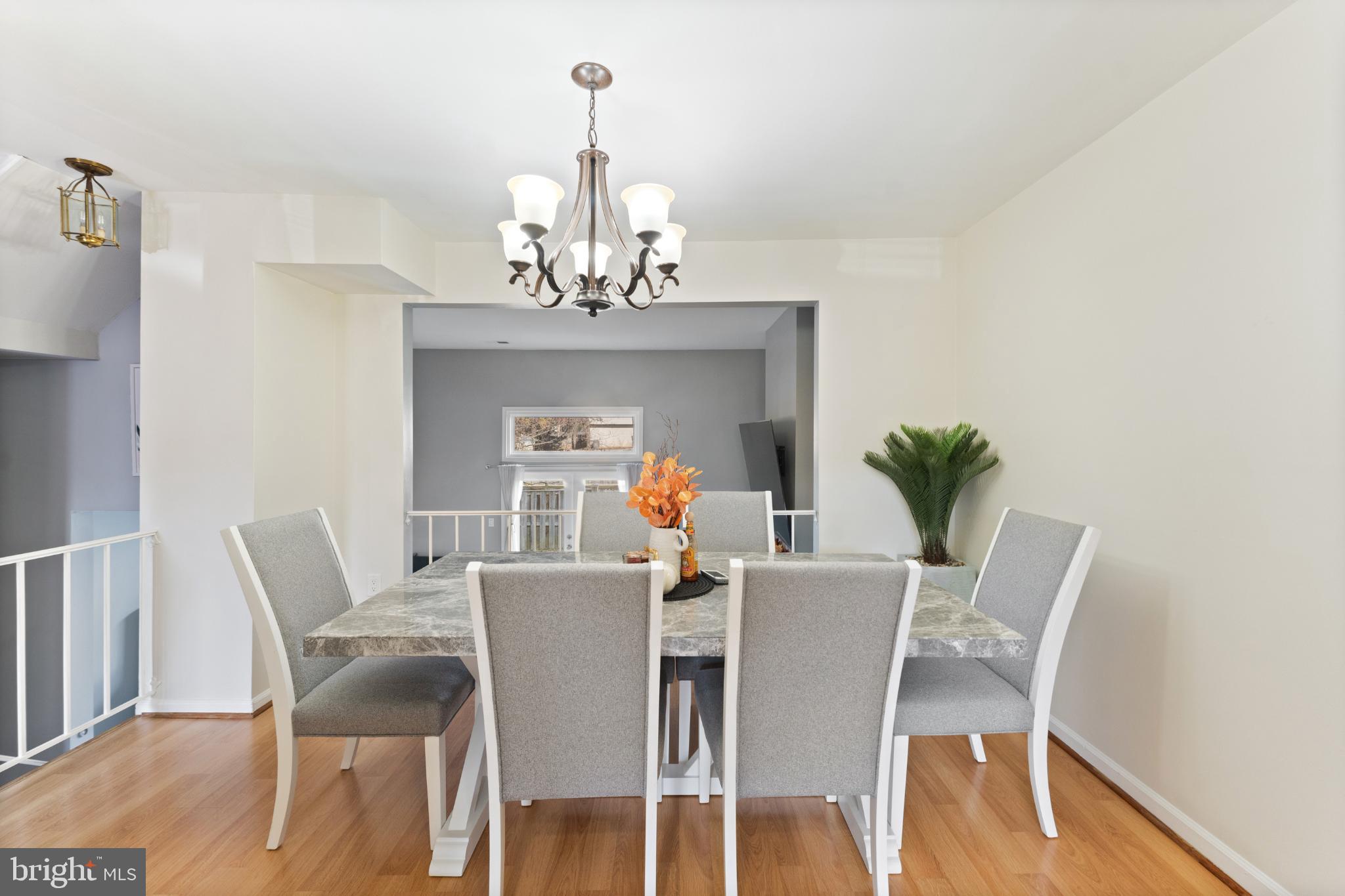 11 Briarstone Lane Gaithersburg, MD 20877 - Photo 8 of 31 a dining room with furniture a chandelier and wooden floor