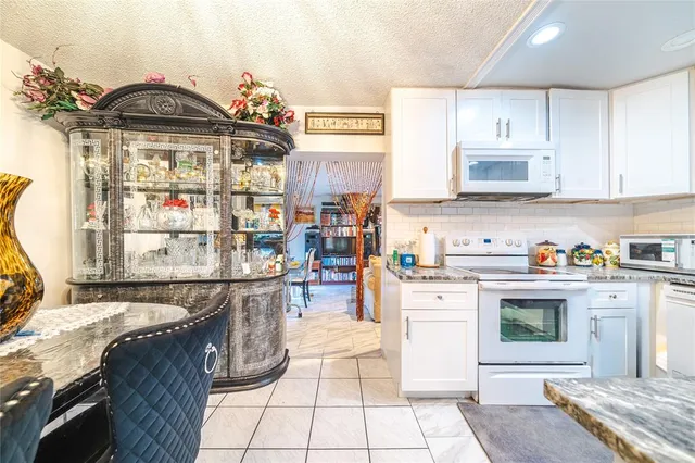 a kitchen with a stove top oven and cabinets