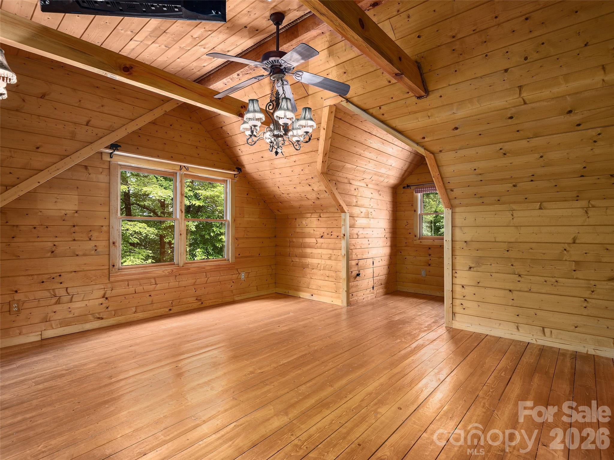 413 Green Hills Road Mill Spring, NC 28756 - Photo 26 of 48 a view of empty room with wooden floor and fan