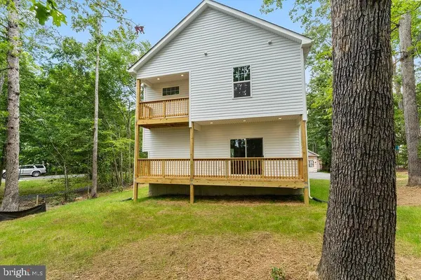 a view of a small house with a yard
