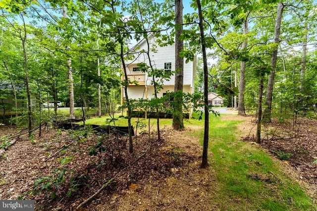 a backyard of a house with lots of green space