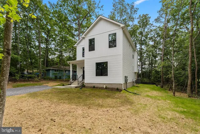 a view of a backyard with table and chairs and wooden fence