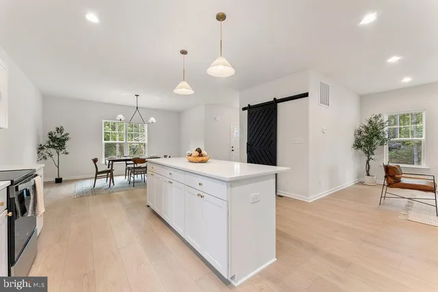 a kitchen with a sink a window and cabinets